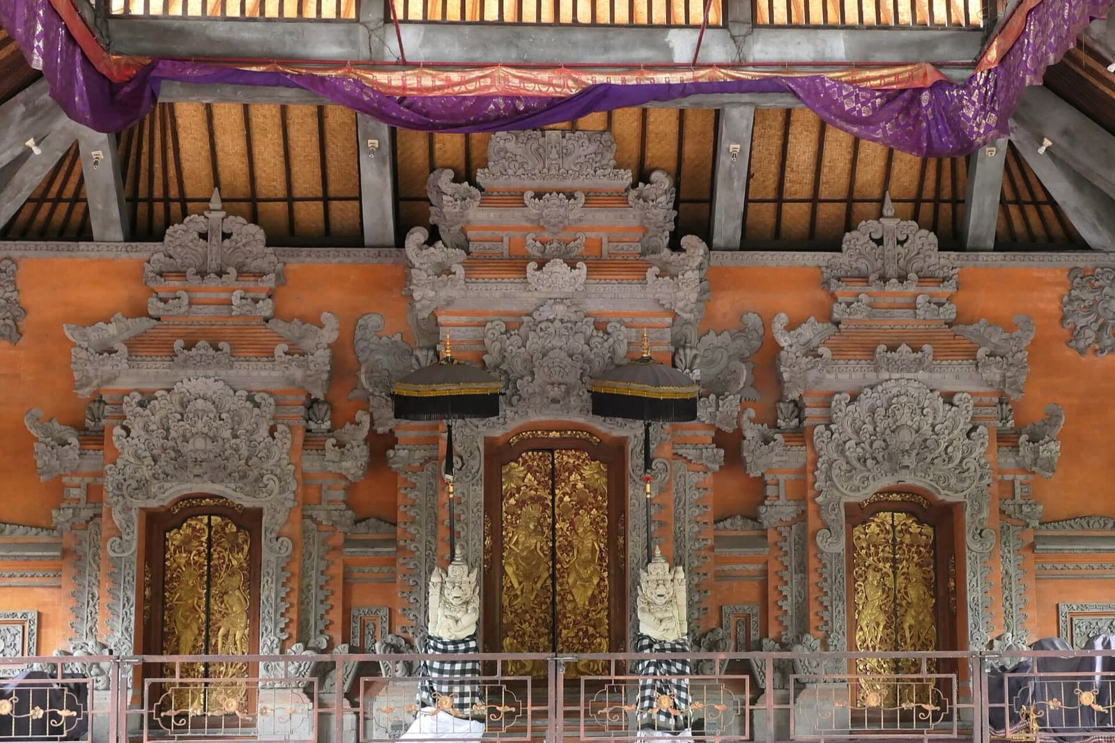 The stage in the main courtyard, with golden doors and stone guardians, where the dances are held