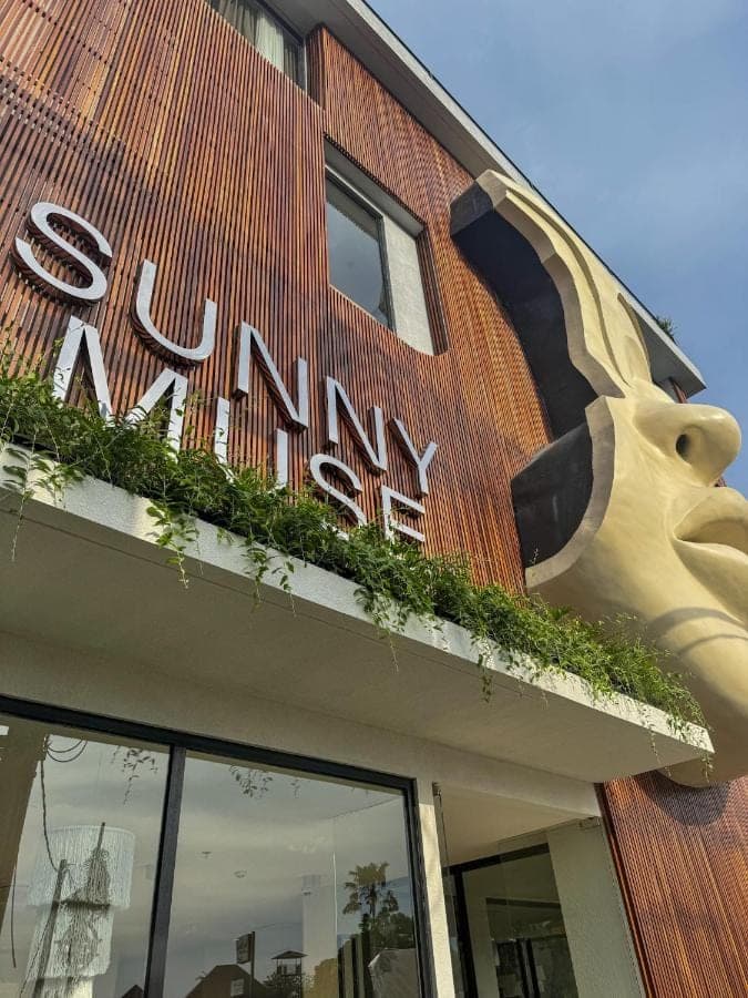 a sign on the side of a building at Sunny Muse by Betterplace in Canggu