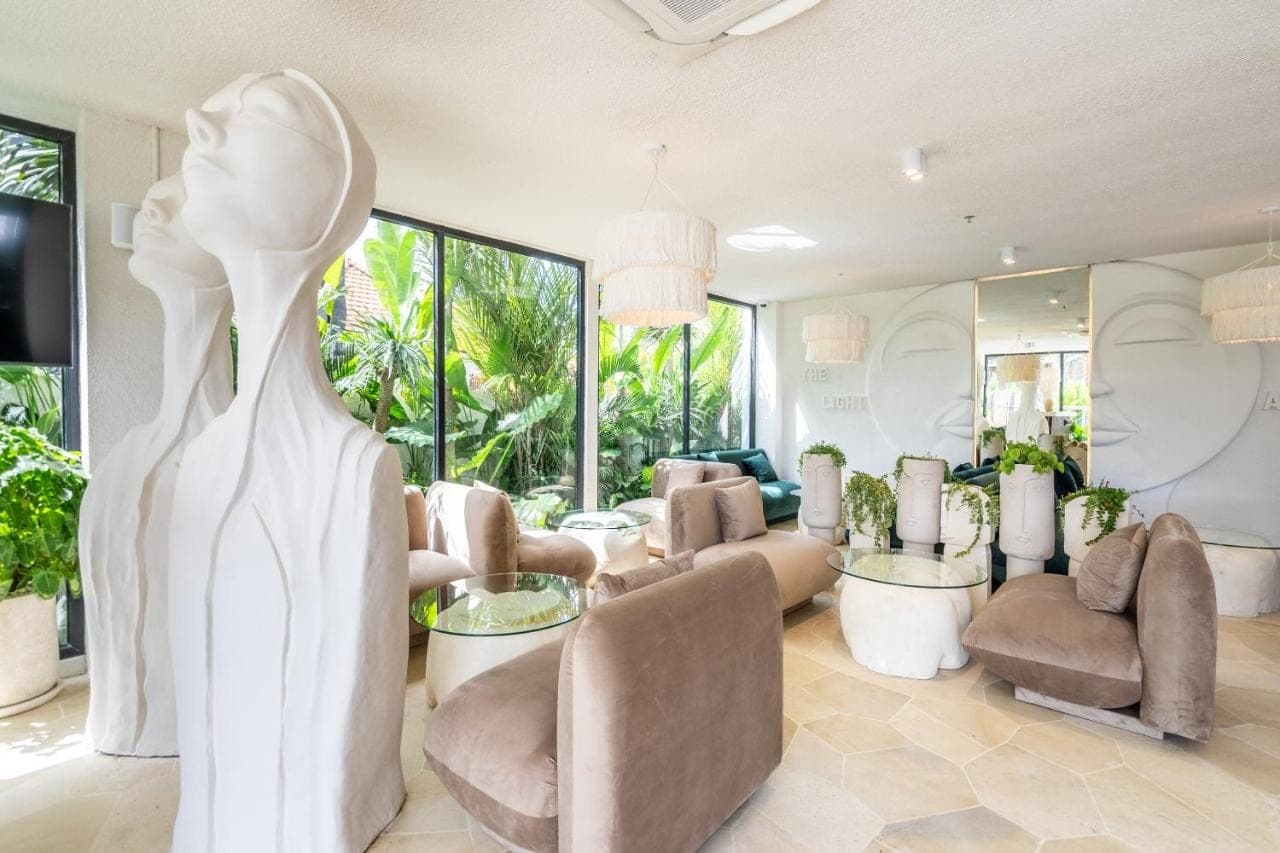 a living room with a statue of a woman at Sunny Muse by Betterplace in Canggu