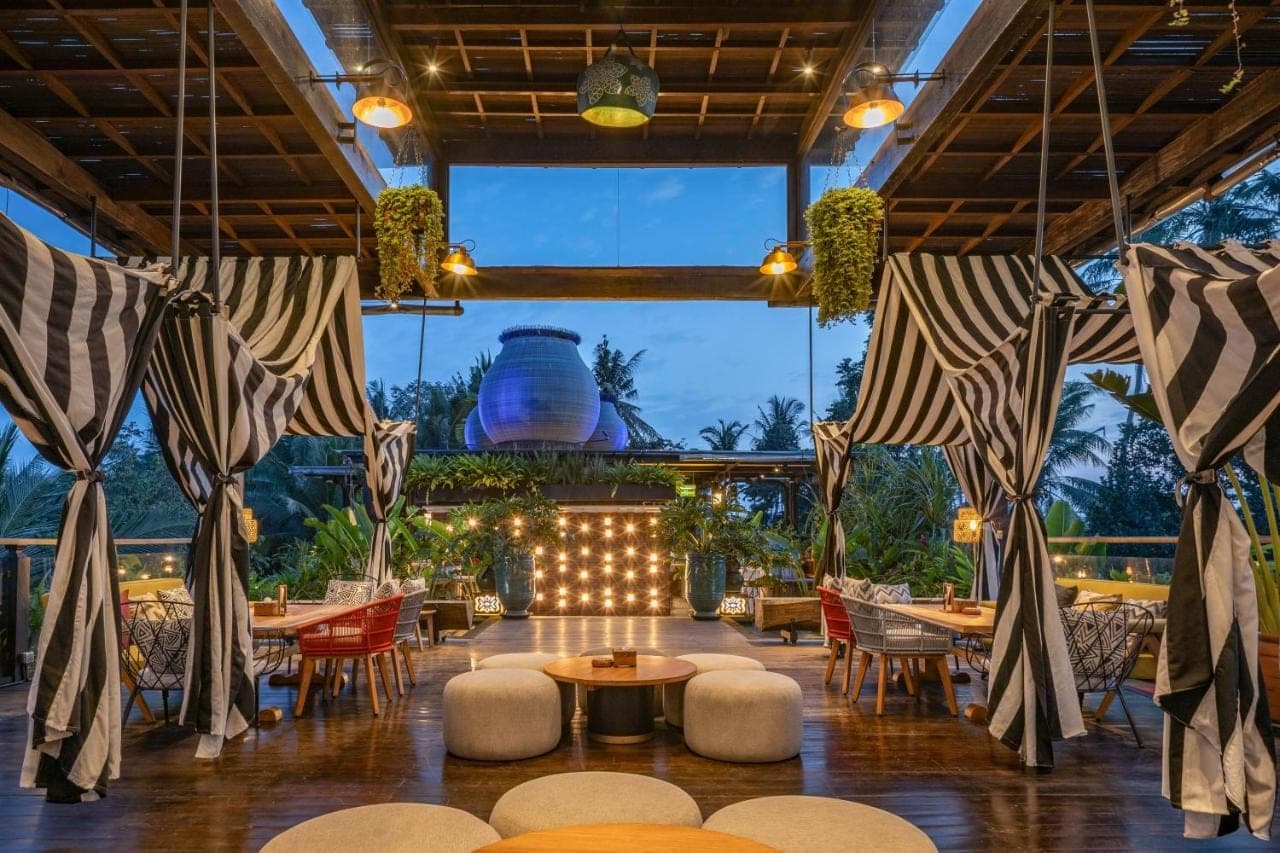 a view of a restaurant with tables and chairs at Arkamara Dijiwa Ubud in Ubud