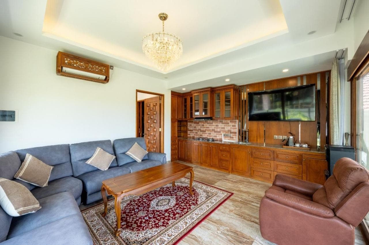 a living room with a couch and a table at MJ Villa Sanur in Sanur