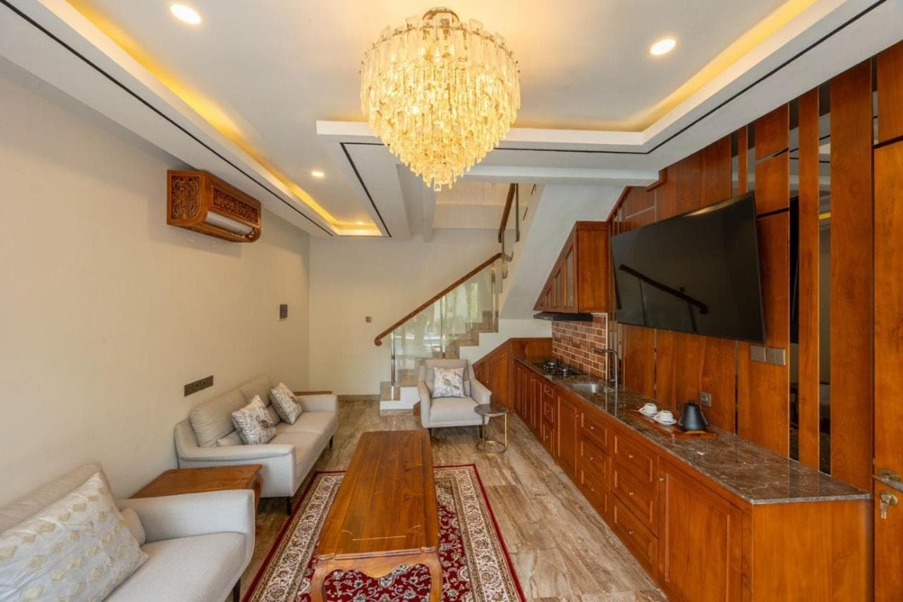 a living room with a tv and a couch at MJ Villa Sanur in Sanur