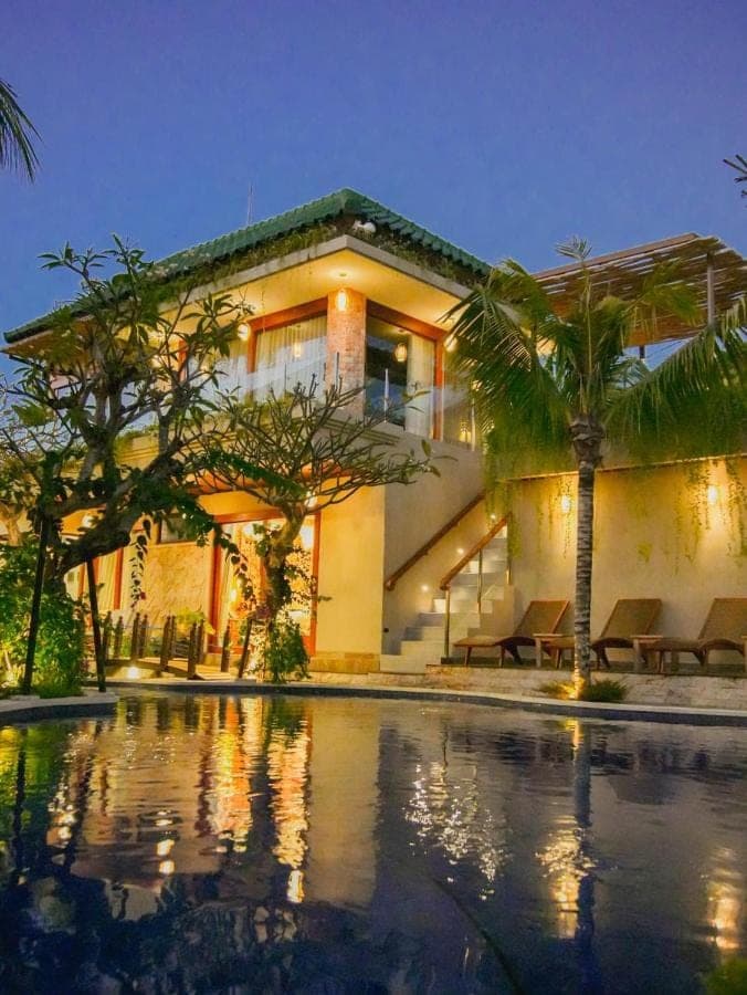 a house with a swimming pool in front of it at MJ Villa Sanur in Sanur