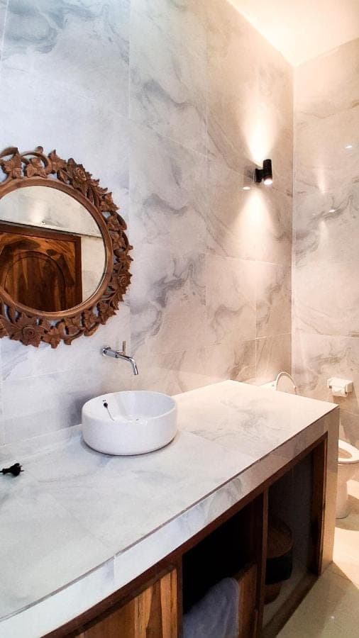 a bathroom with a sink and a mirror at Heritage Stay in Uluwatu