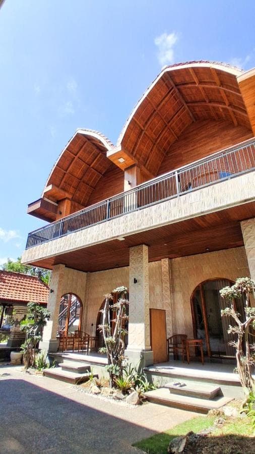 a large building with a balcony on top of it at Heritage Stay in Uluwatu