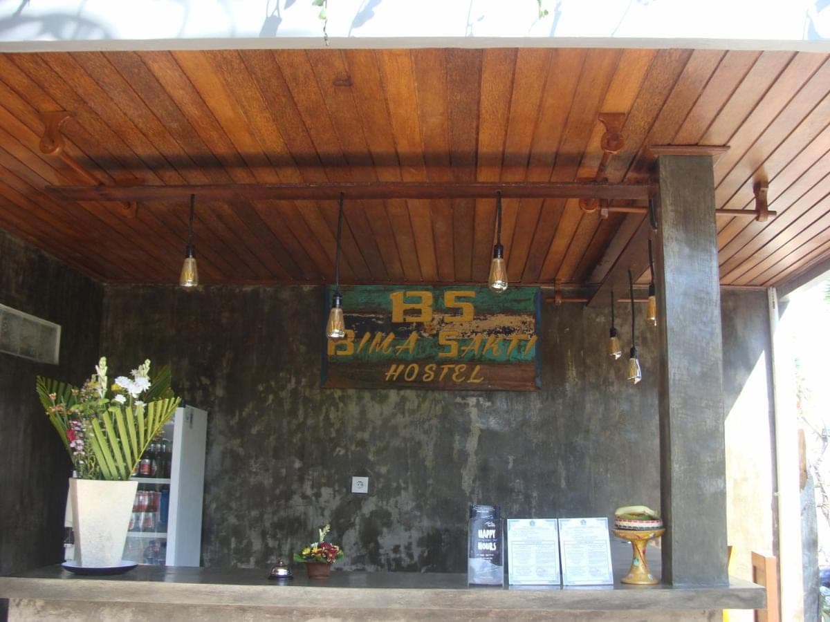 a bar with a sign on the wall of a restaurant at Bima Sakti Homestay Echo Beach Canggu in Canggu