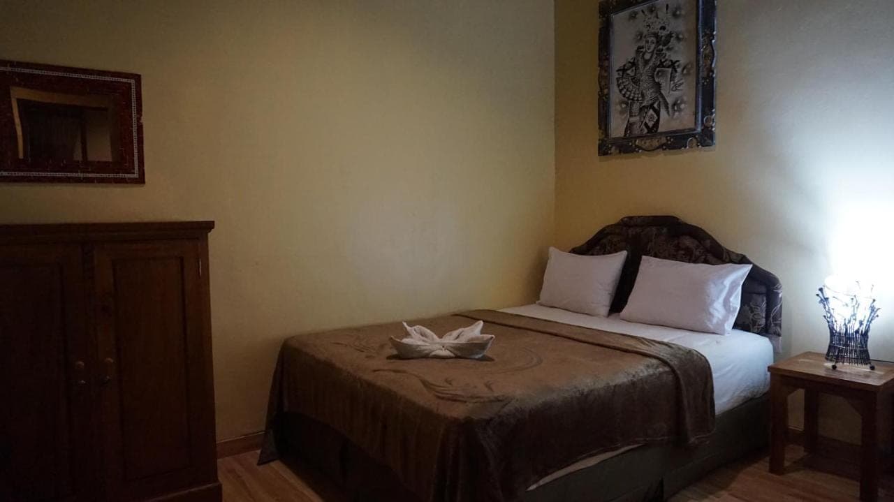 a bedroom with a bed with a bowl on it at Bima Sakti Homestay Echo Beach Canggu in Canggu