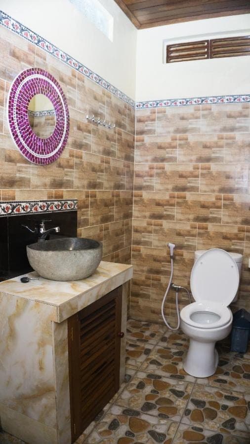 a bathroom with a sink and a toilet at Bima Sakti Homestay Echo Beach Canggu in Canggu