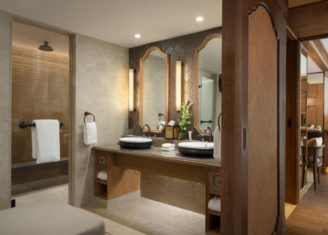 a bathroom with two sinks and a large mirror at Hyatt Regency Bali in Sanur
