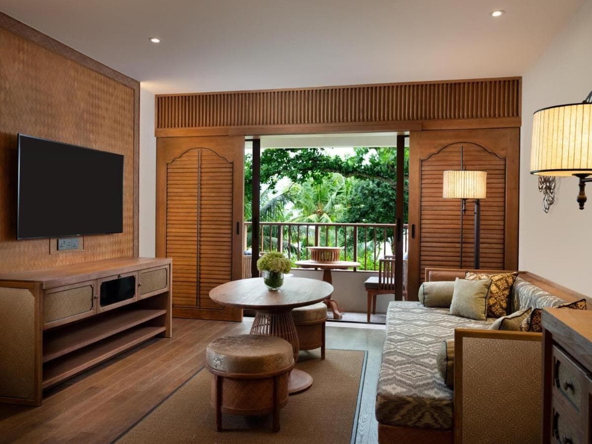 a living room with a couch and a tv at Hyatt Regency Bali in Sanur