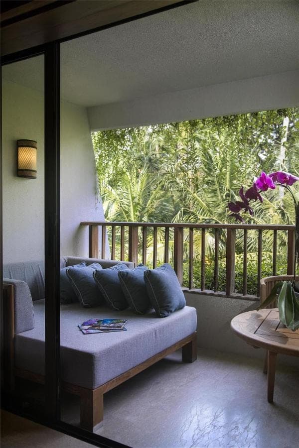 a living room with a couch on a balcony at Hyatt Regency Bali in Sanur