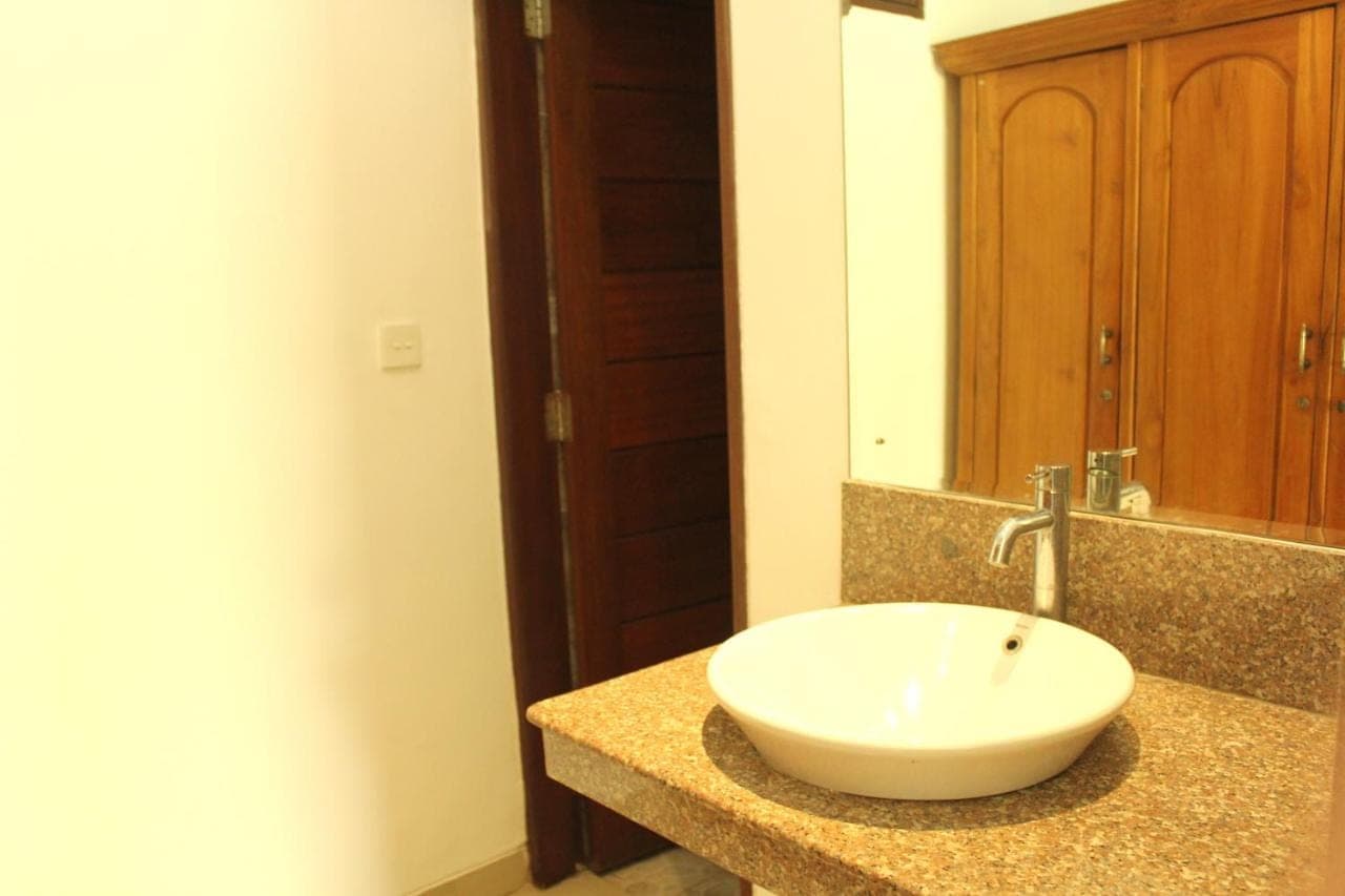 a bathroom with a white sink and a mirror at Yulia 1 in Sanur