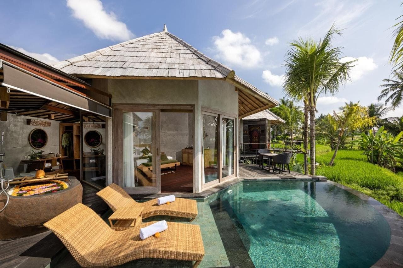 a villa with a swimming pool and a patio at thewakanda Resort A Pramana Experience in Ubud