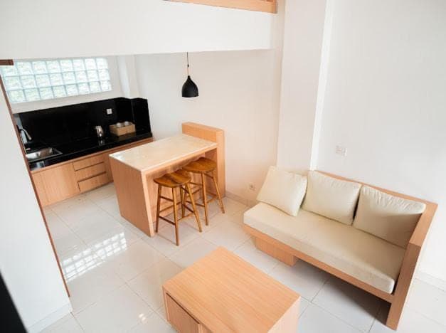 a living room with a couch and a table at Aspen bali nusa dua in Nusa Dua
