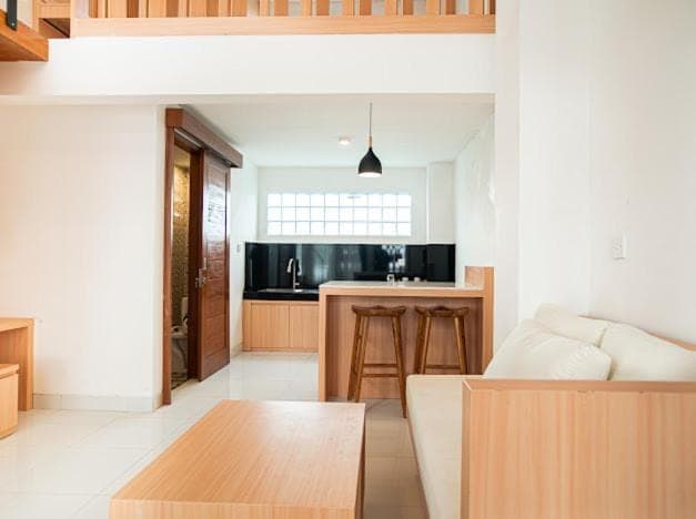 a kitchen and living room with a couch and a table at Aspen bali nusa dua in Nusa Dua