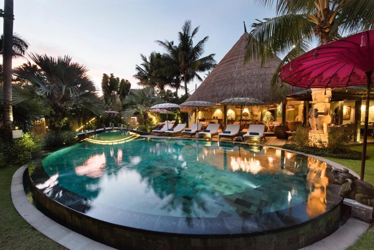 a large swimming pool in front of a resort at Blue Karma Seminyak in Seminyak