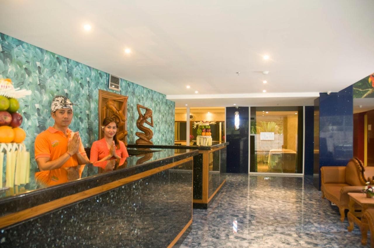 two people standing at a bar in a hotel lobby at Sulis Beach Hotel &amp; Spa in Kuta