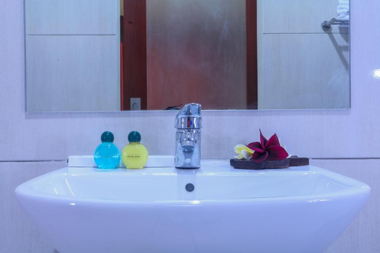 a bathroom sink with a faucet and two ducks on it at Sekar Waru Homestay in Sanur