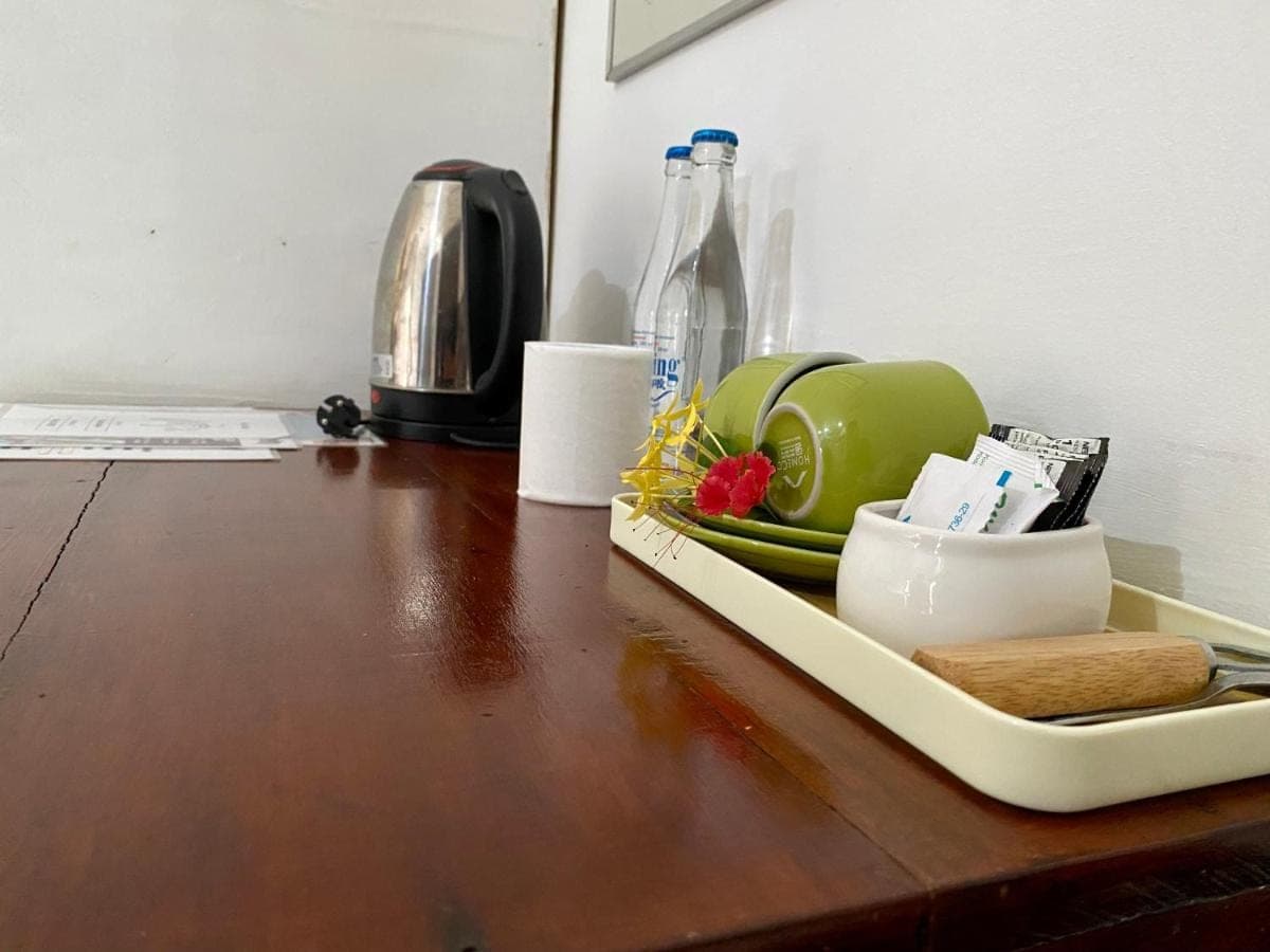 a tray filled with dishes on a wooden table at Milla's Homestay in Sidemen