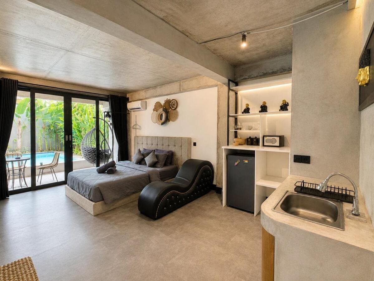 a bedroom with a bed and a sink at Balissimo - 1BR Pool View Studio Seminyak in Seminyak