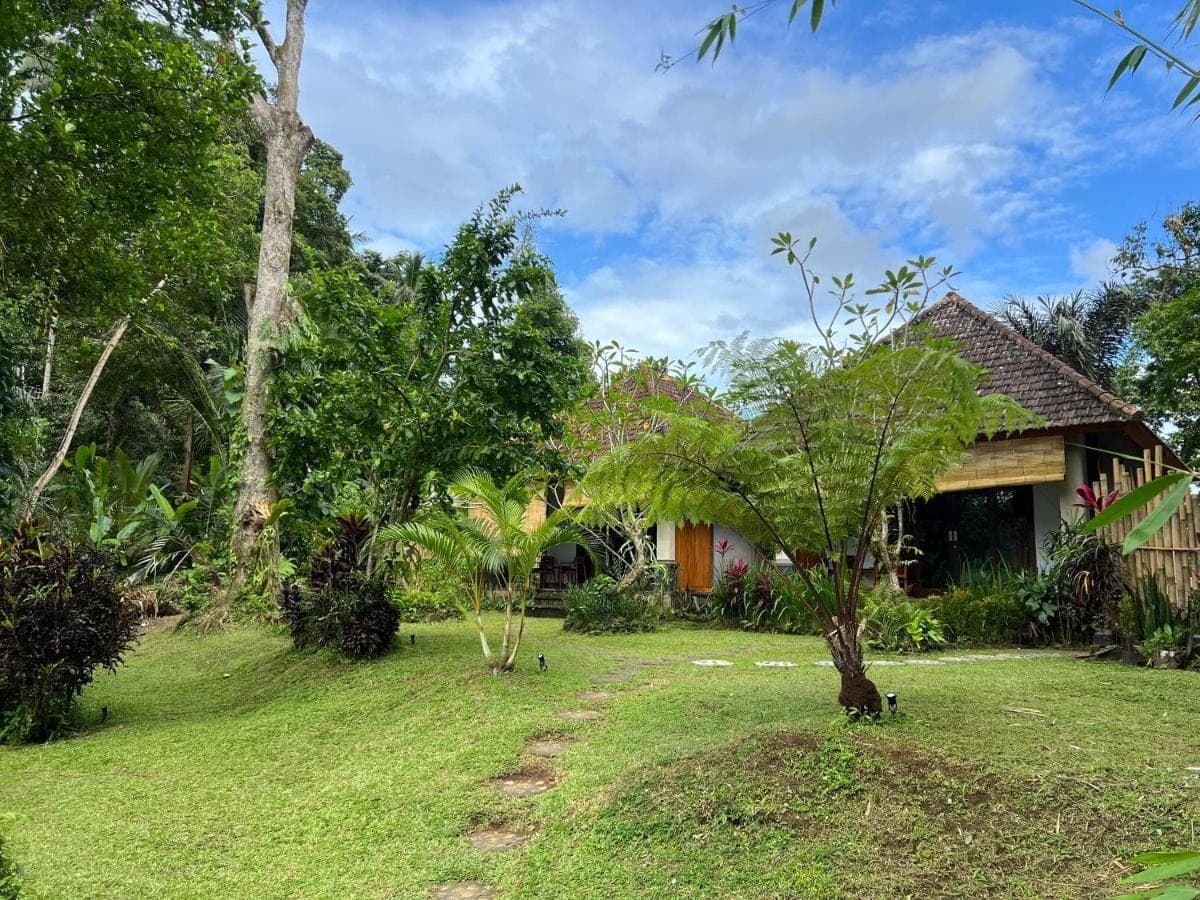 a house in the middle of a yard at Abian view house in Sidemen