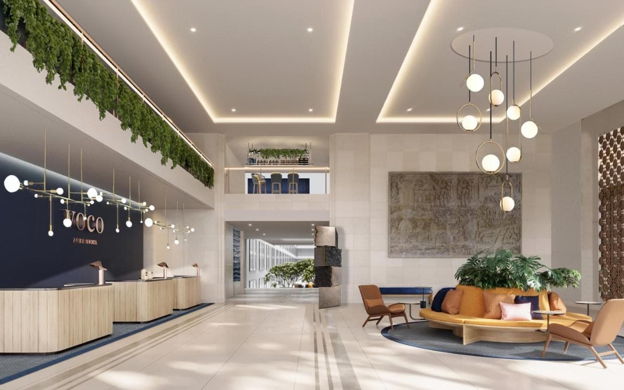 a lobby with a waiting area with a couch and chairs at voco Bali Seminyak by IHG in Seminyak