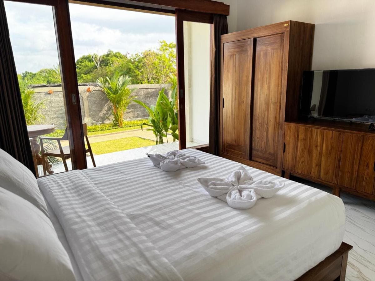 a bedroom with a bed with two bowls on it at D\u00e9 Kamala Bali in Nusa Dua