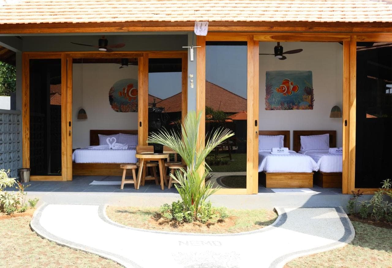a guest house with two beds and a patio at Aqua Dive resort Amed in Amed