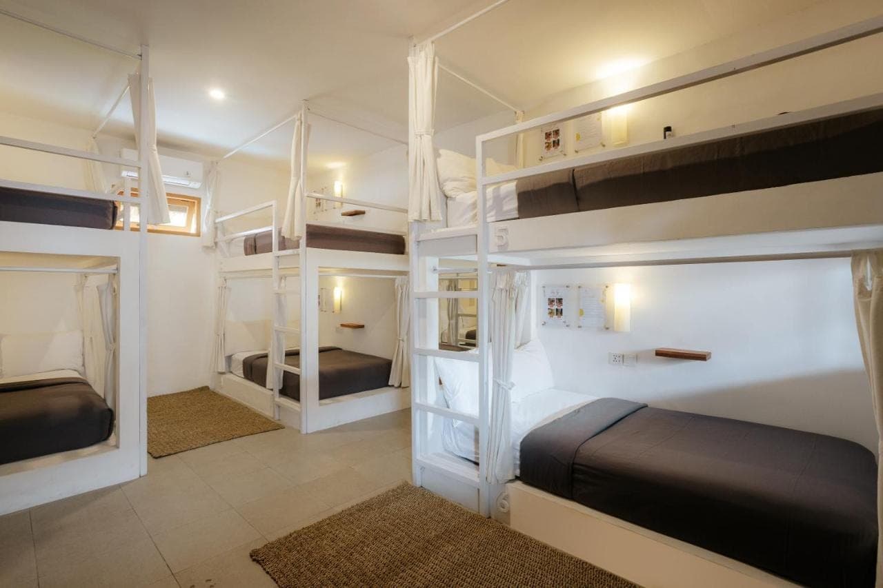 a bedroom with two bunk beds in a room at Puri Garden Hotel &amp; Hostel in Ubud
