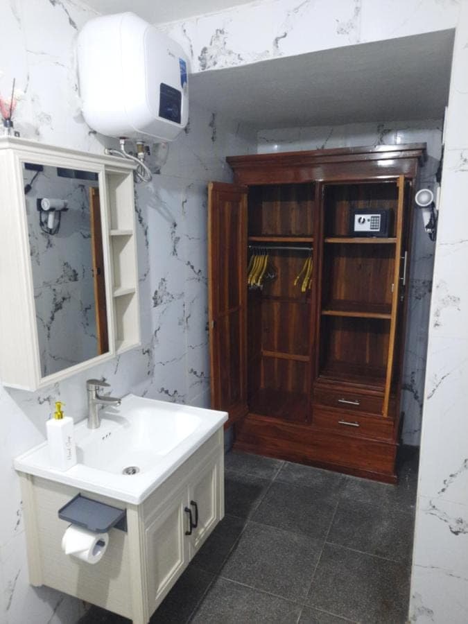 a bathroom with a sink and a medicine cabinet at Pondok Klumpu in Nusa Dua