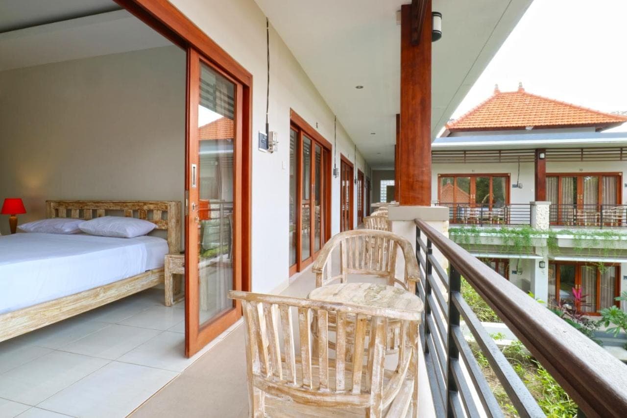 a balcony with a bedroom and a bed on a balcony at Avisara Nusa Dua in Nusa Dua