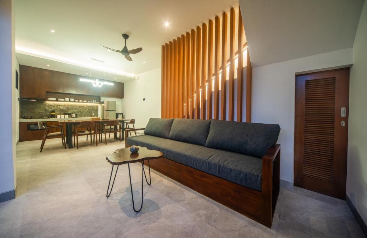 a living room with a couch and a table at 3Bedroom - 703 - Private Pool Villa Sanur in Sanur