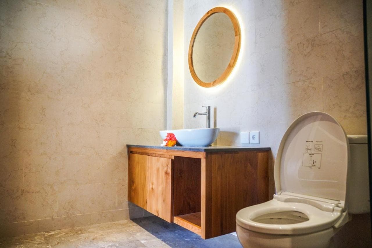 a bathroom with a sink and a toilet at Bisma Terrace Suite Ubud in Ubud
