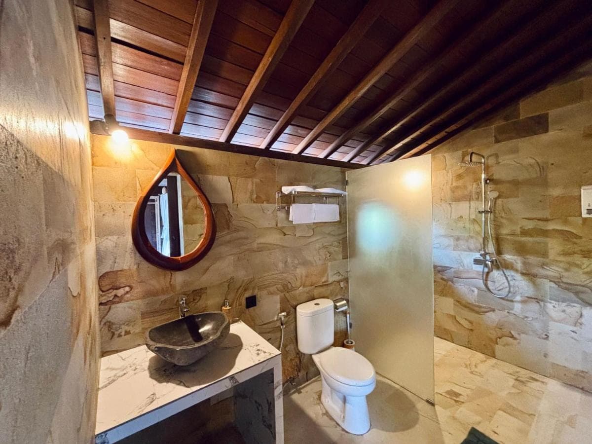 a bathroom with a toilet and a sink at The Atlas Villas in Amed