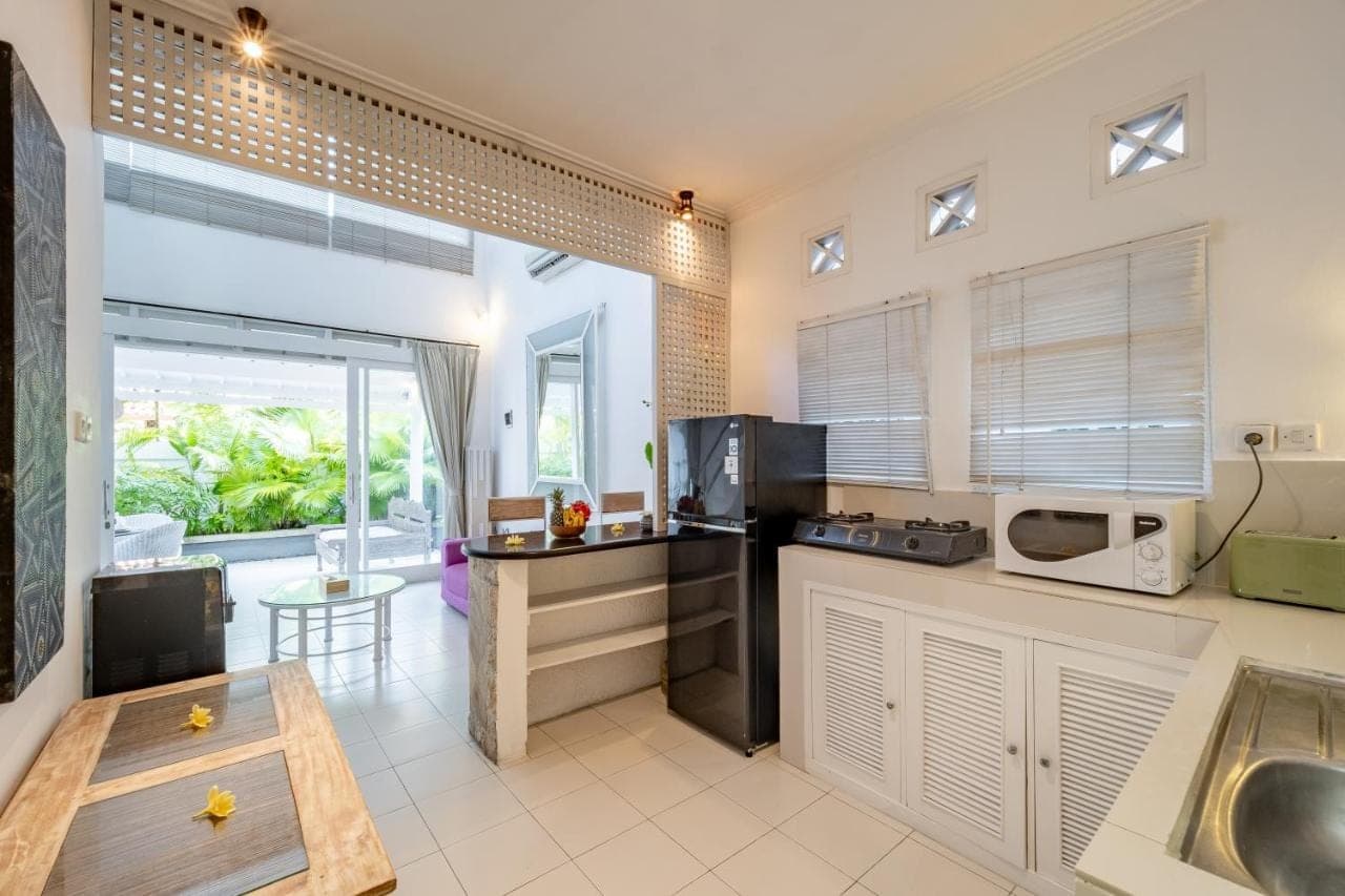 a kitchen with a sink and a counter top at Villa Margaretta in Seminyak