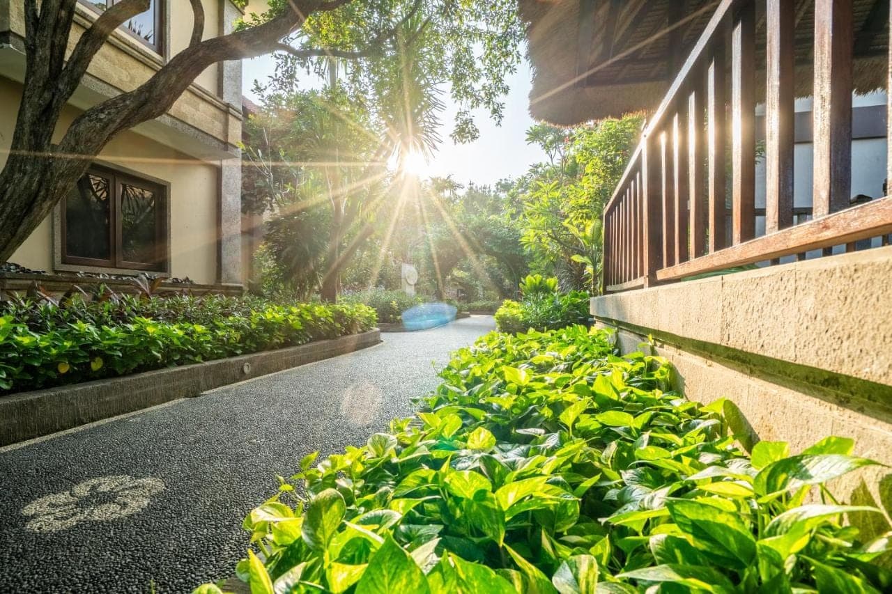 a row of green plants next to a building at Risata Bali Resort &amp; Spa in Kuta