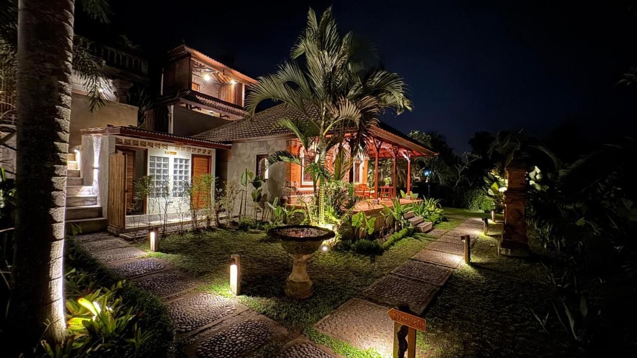 a house with lights in the yard at night at Villa Karma Loka in Sidemen