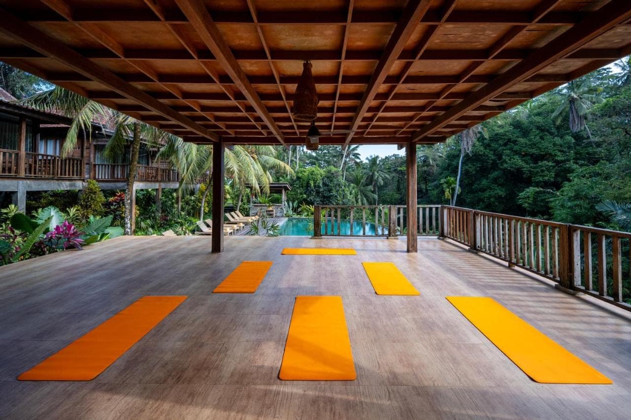 a wooden deck with orange squares on it at Pertiwi Bisma 1 in Ubud