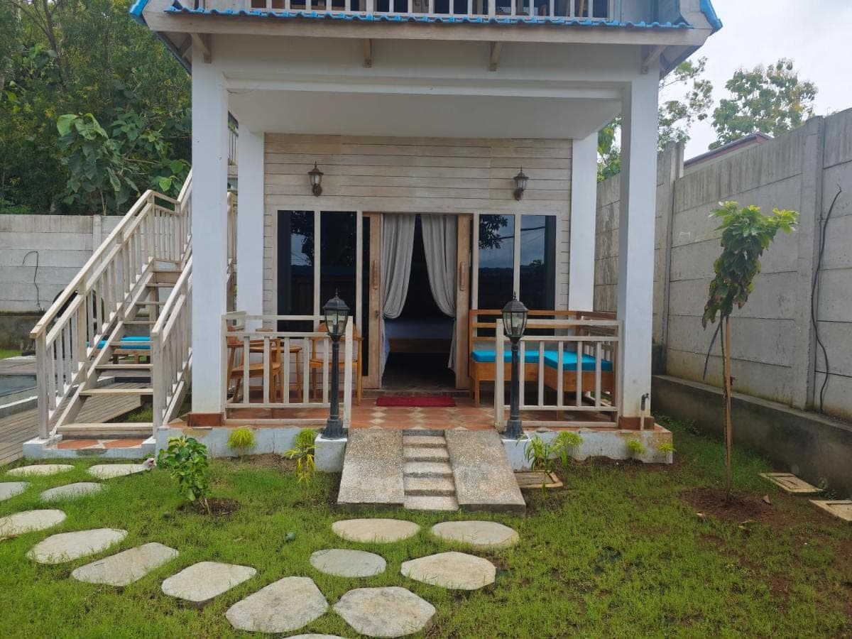 a small house with a porch and a walkway at Nanun Paradise Uluwatu in Uluwatu