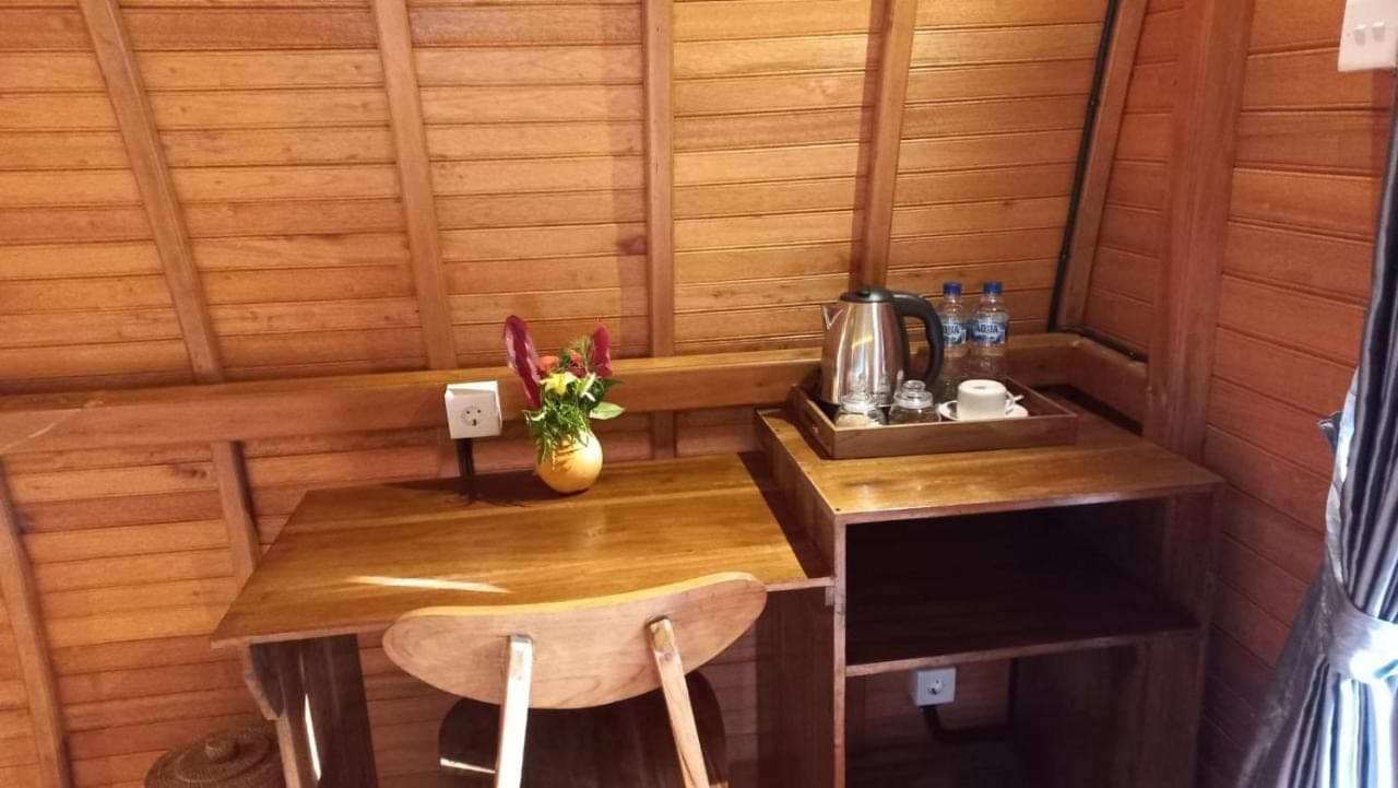 a small room with a wooden table and a sink at Lumbung Intan in Sidemen