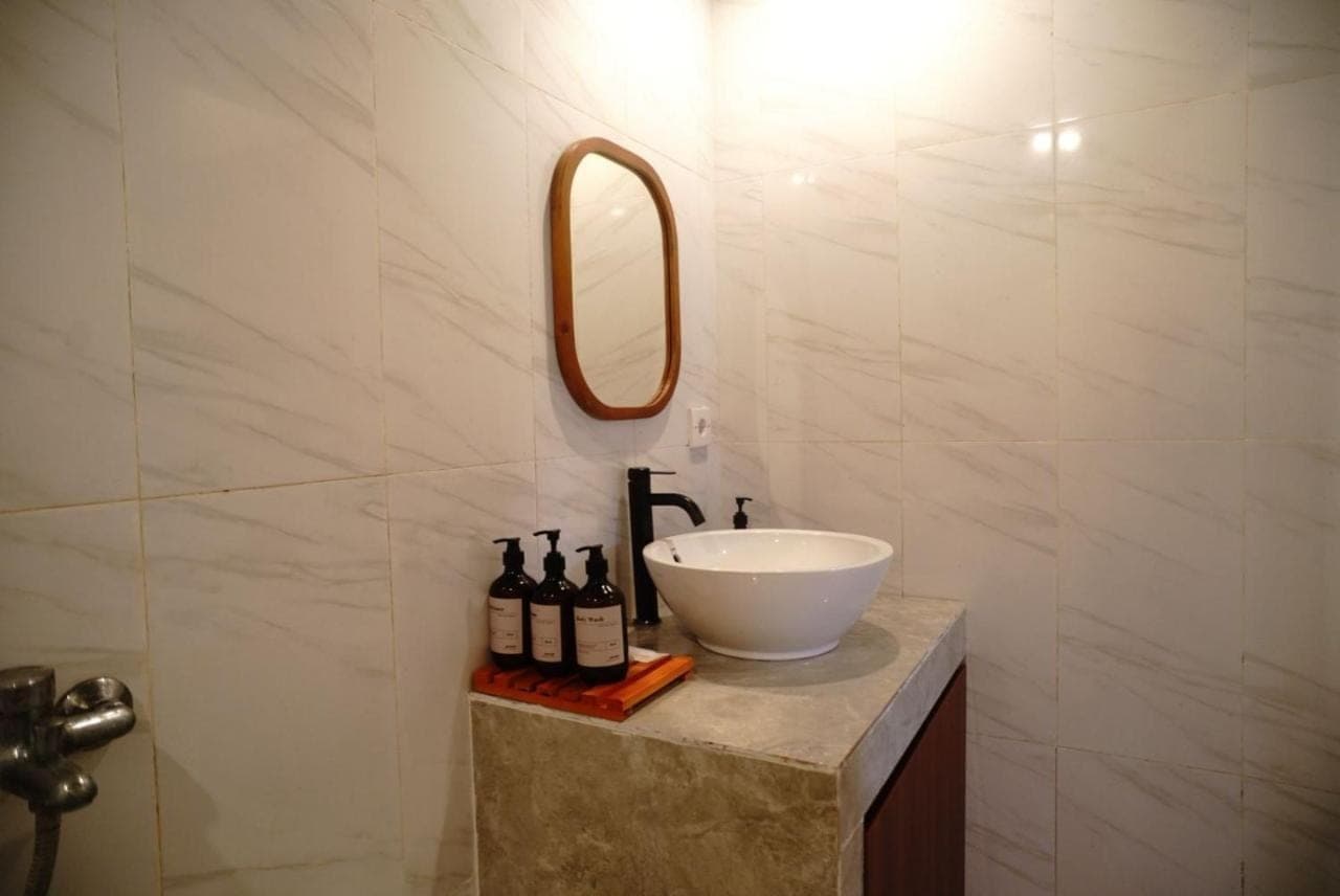 a bathroom with a white sink and a mirror at The Gong in Uluwatu