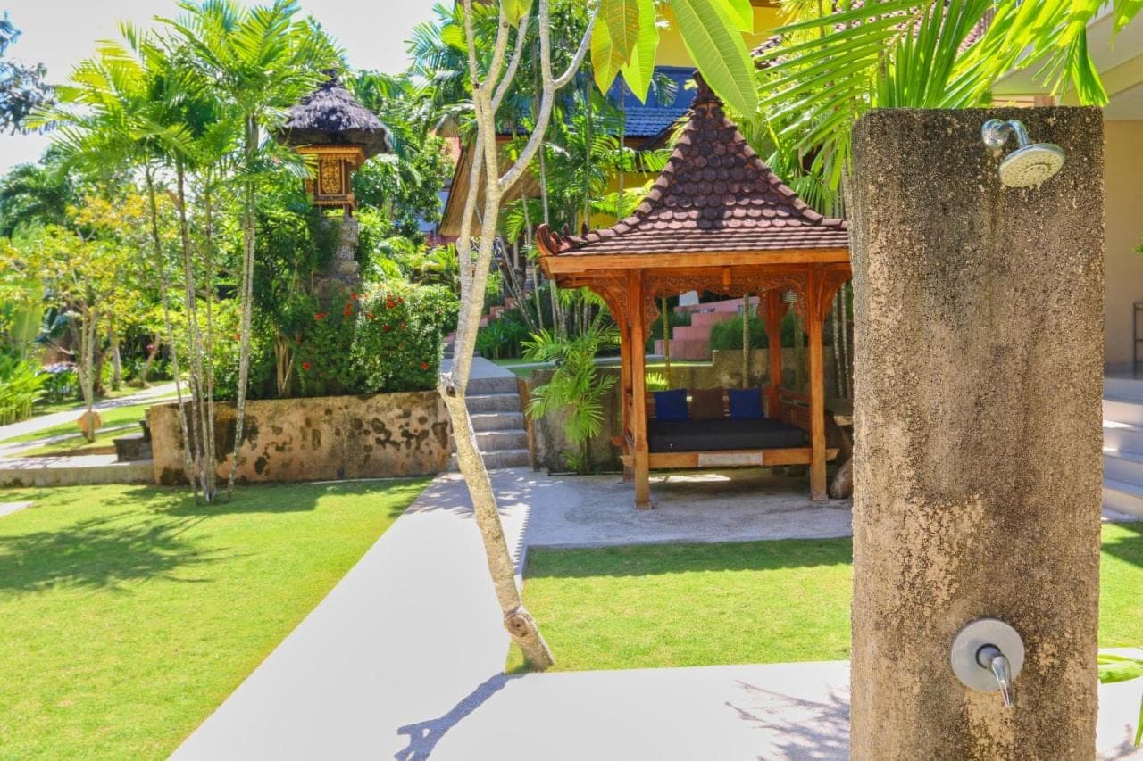 a gazebo in a garden with a swing at The Gong in Uluwatu
