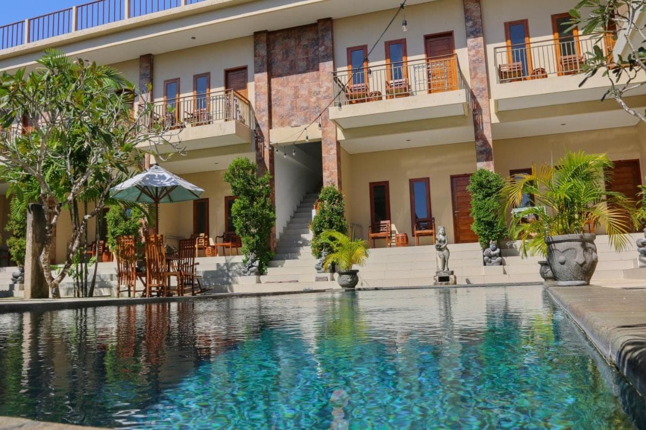 a swimming pool in front of a building at The Gong in Uluwatu