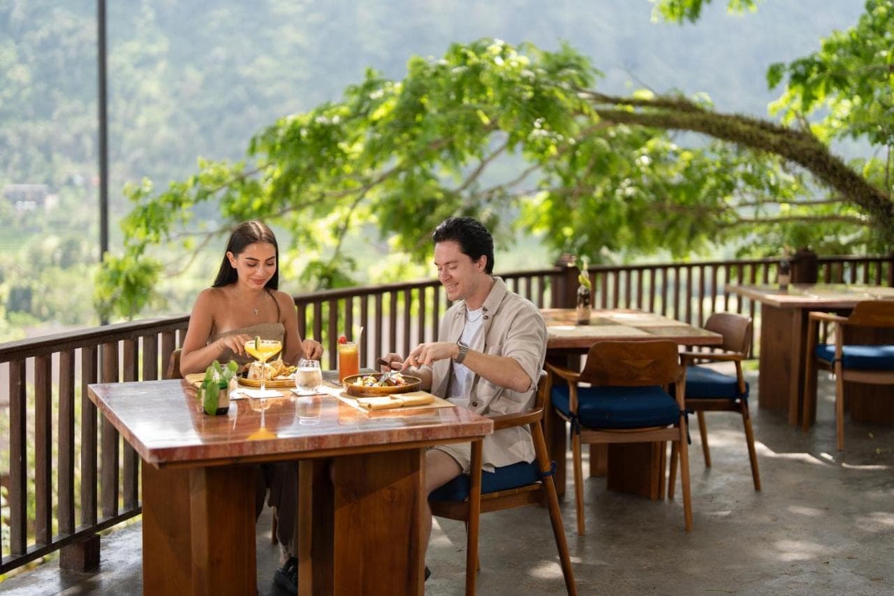 a man and a woman sitting at a table in a restaurant at Kropak Sidemen in Sidemen