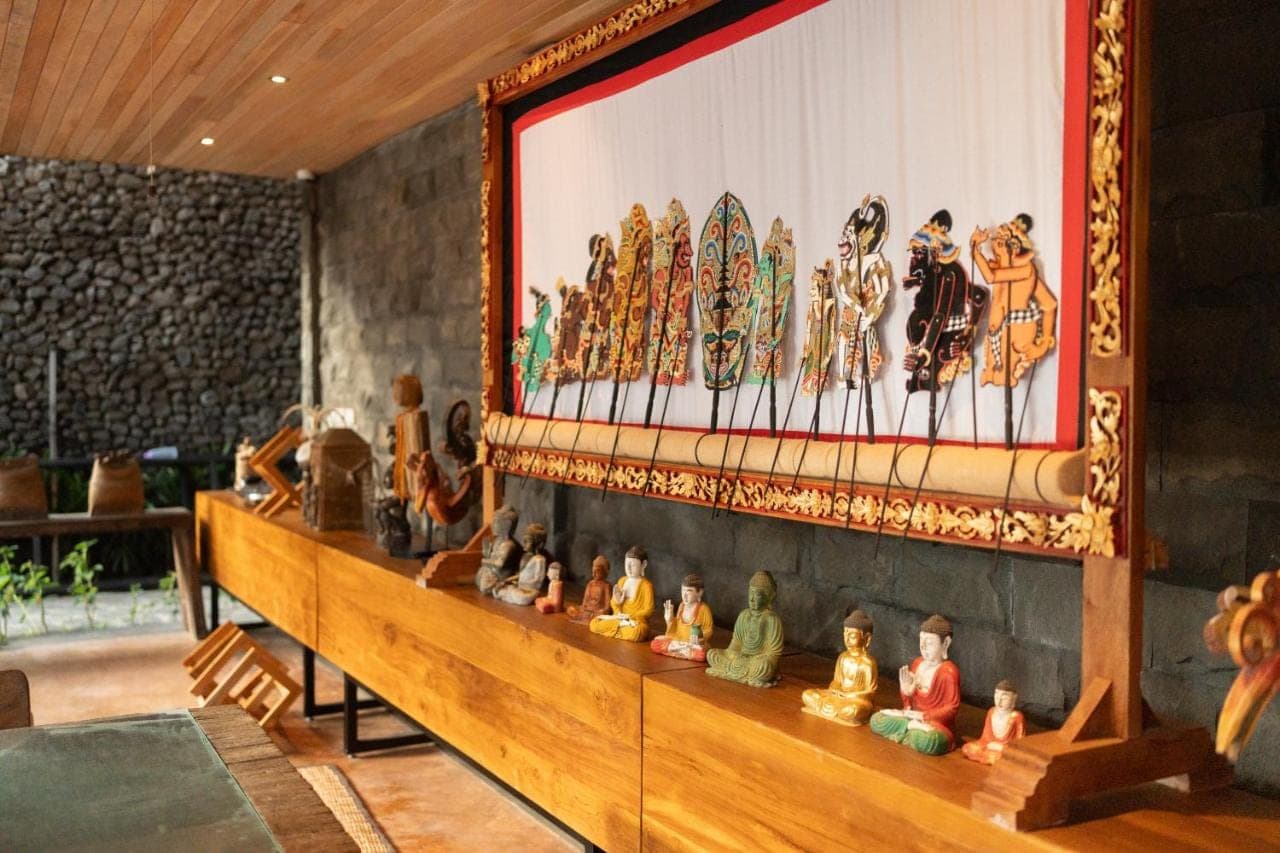 a group of figurines on a shelf in a room at Kropak Sidemen in Sidemen