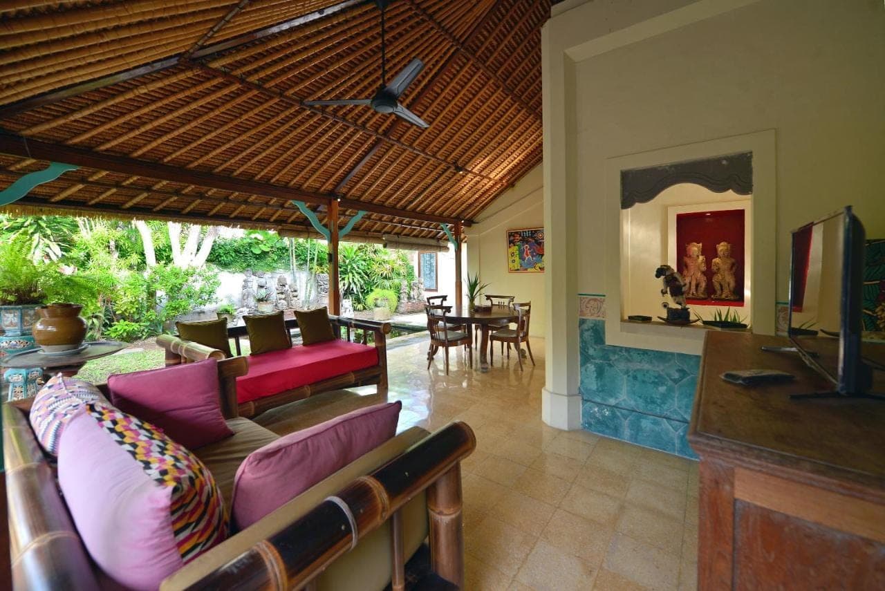 a living room with a couch and a table at Bebek Cottages Sanur in Sanur