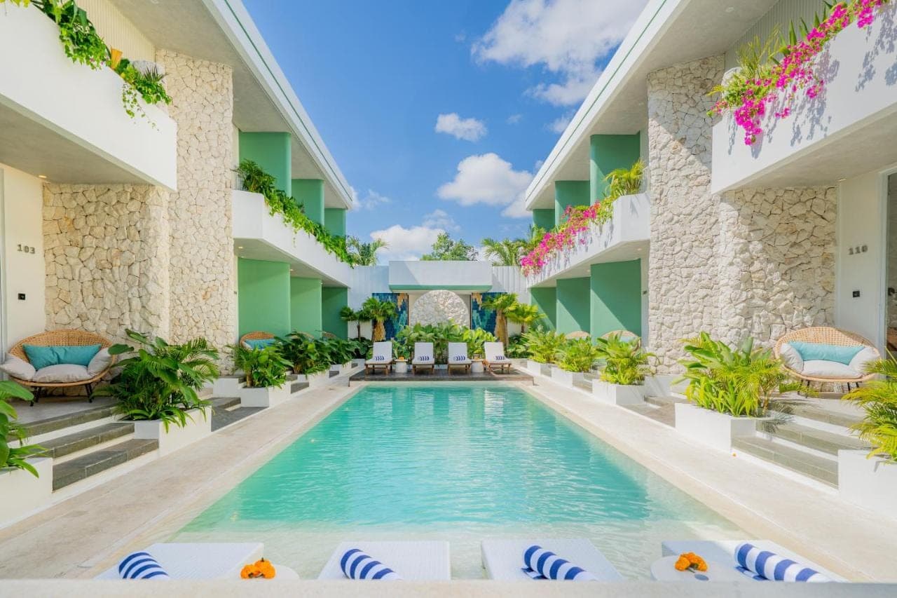 a swimming pool in the middle of a hotel at Lomo Boutique Hotel &amp; Villas, Uluwatu in Uluwatu