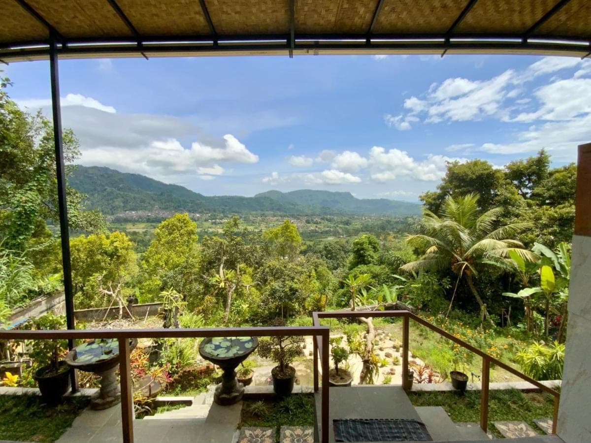 a view of the mountains from the balcony of a house at Rumah Bagus Jayanti in Sidemen