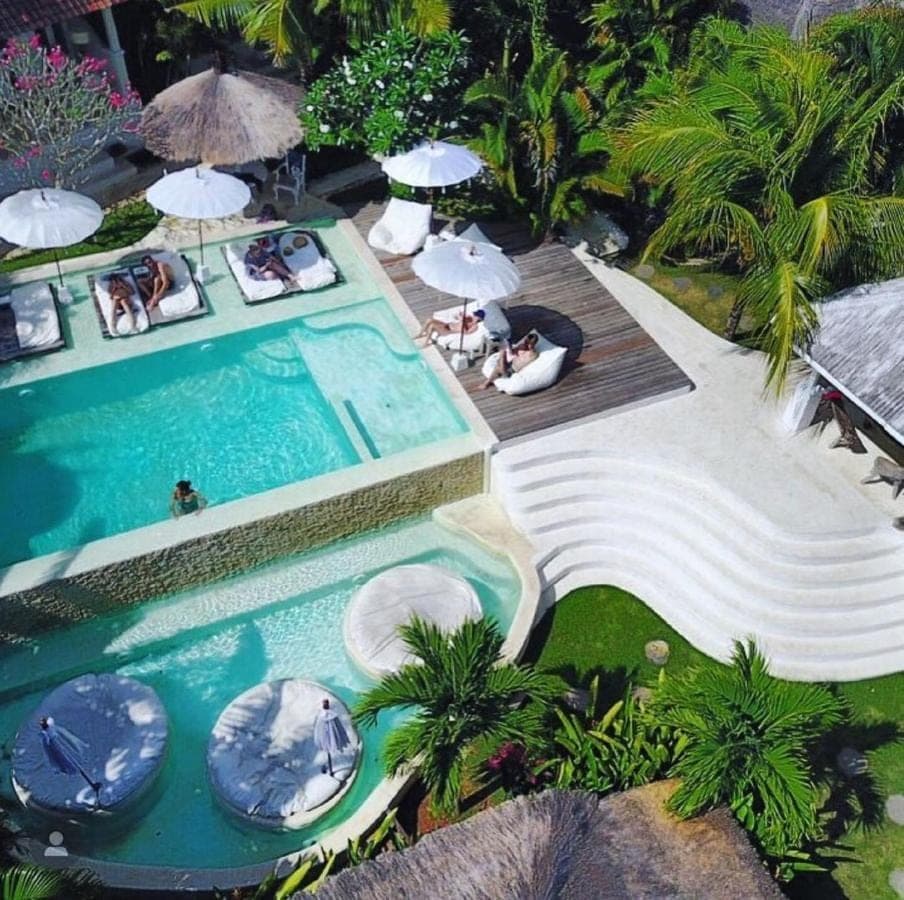 an overhead view of a swimming pool with umbrellas at Sal Secret Spot in Uluwatu