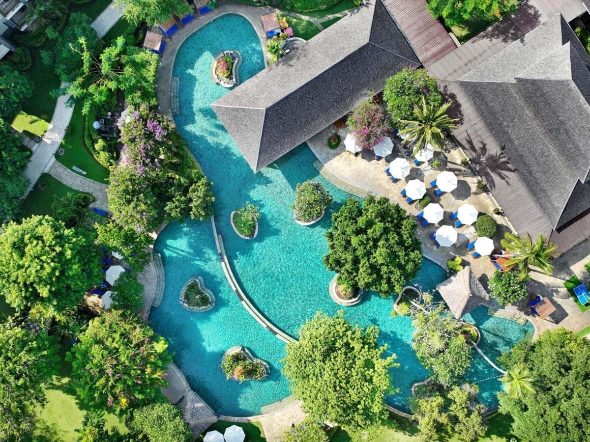 an aerial view of a swimming pool in a park at Novotel Bali Nusa Dua in Nusa Dua